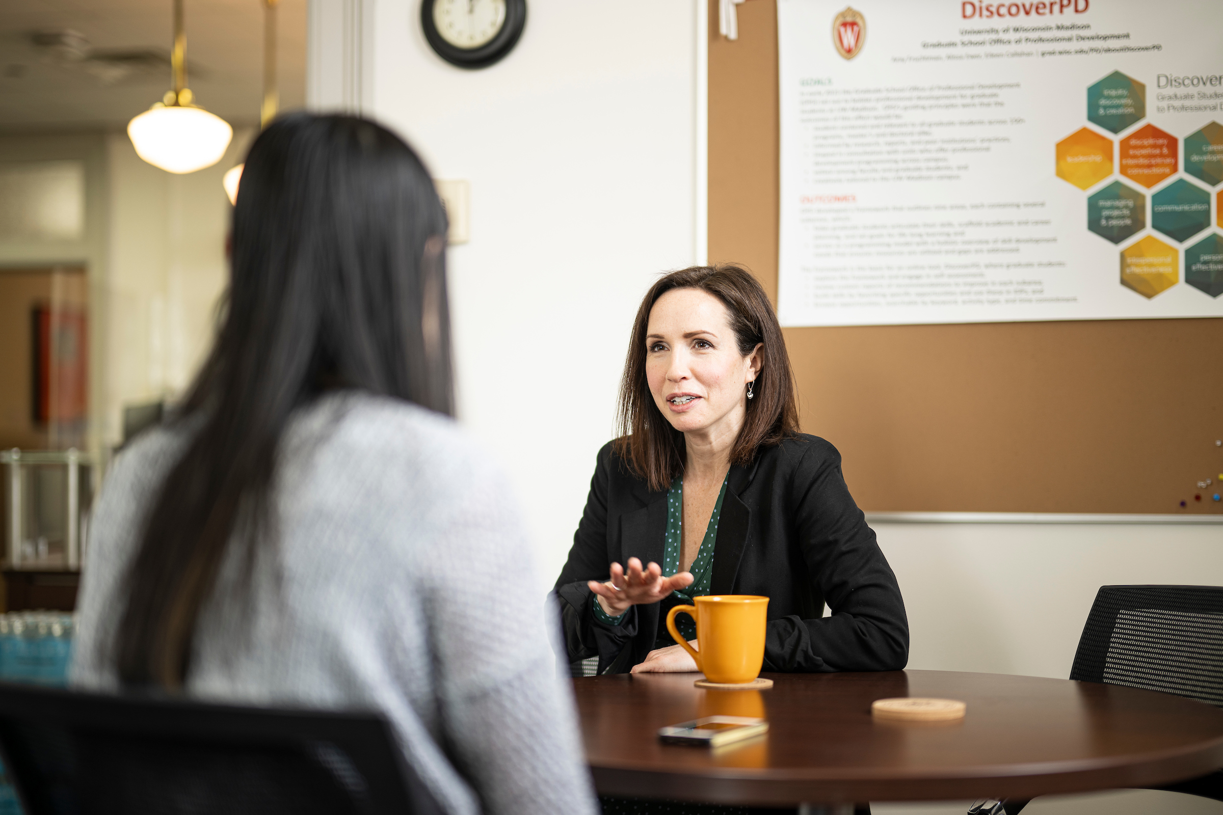 Two women talking at a table 